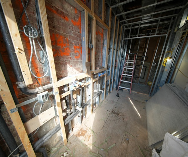 Interior construction with exposed pipes and framing